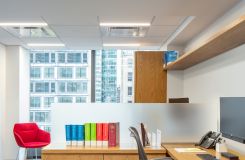 A shared NEW MILLENNIA office features adjustable-height worksurfaces and integral finger pulls. thumbnail